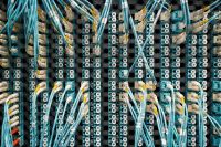 White and blue cables at the back of an Internet Server Rack White and blue cables at the back of an Internet Server Rack